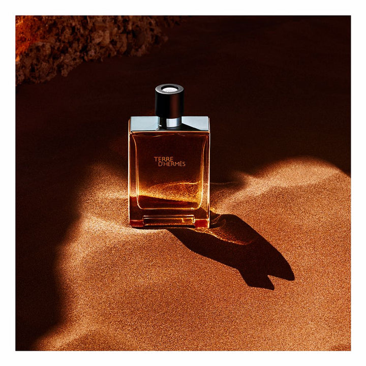 Rectangular glass bottle with metal shoulders; 100 ml woody-citrus perfume for Man