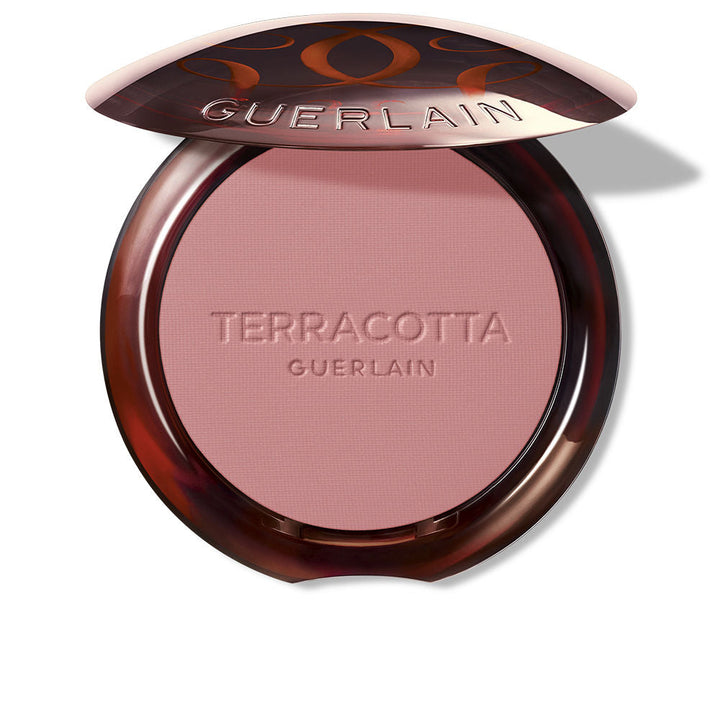 Guerlain Round glossy-lidded plastic compact showing pressed pink and brown powder blush, refined craftsmanship .