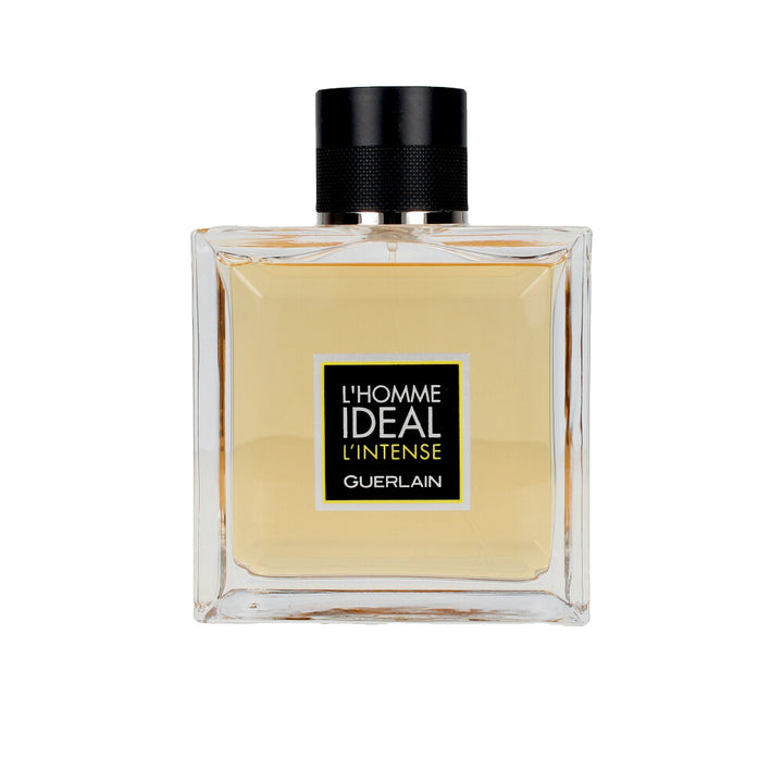 Clear square glass bottle with light amber liquid, black textured cap and simple front label, Guerlain.