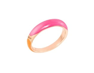 Gold ring with pink and orange enamel panels in a modern low-profile band on white background