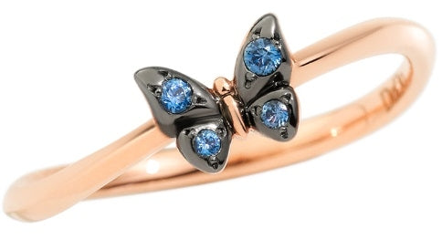 Rose gold and black metal butterfly ring set with blue gemstones on white background