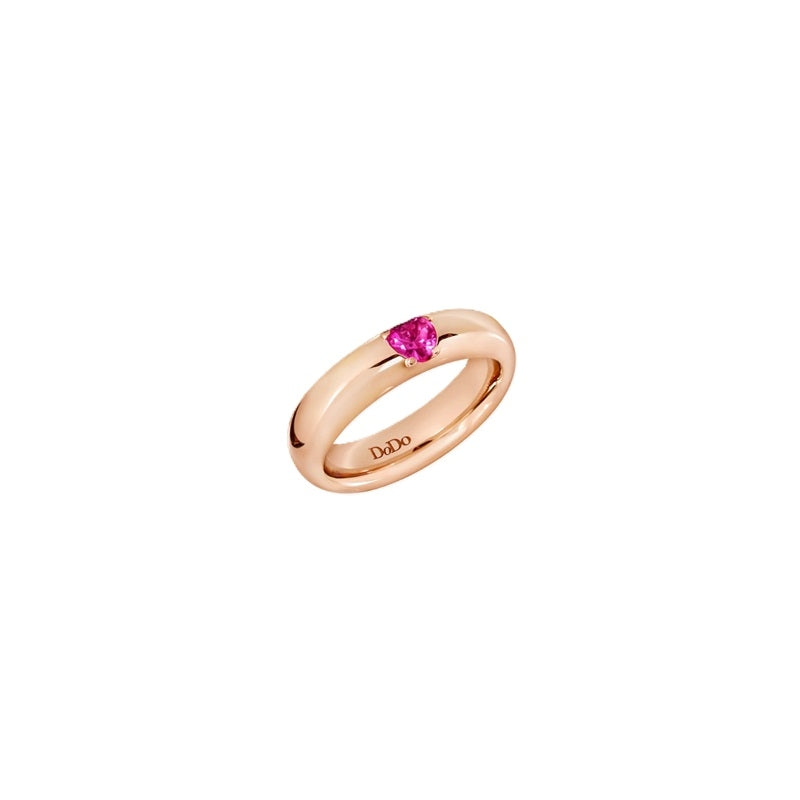 Rose gold ring featuring a heart-shaped pink gemstone on a polished band against a neutral background