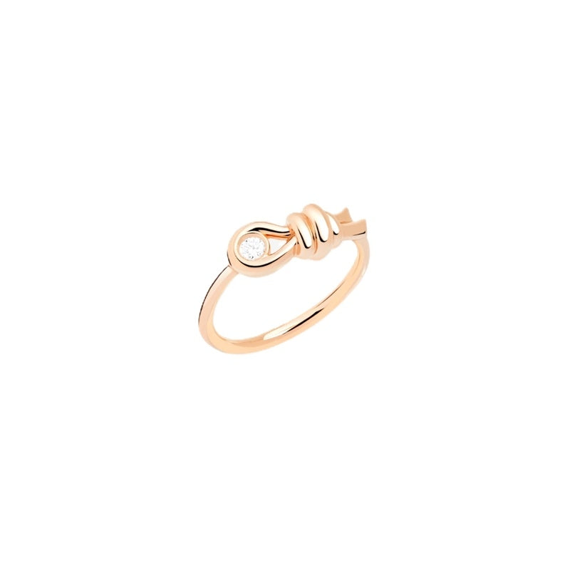 Rose gold knot ring featuring a single embedded diamond on polished band, shown on white background