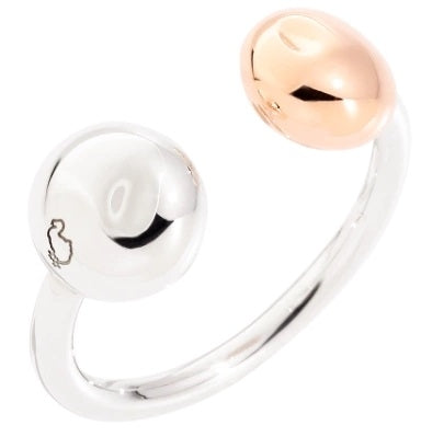 Two-tone open cuff bracelet in silver and rose gold with polished sphere terminals on a neutral background